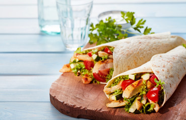 Two fresh chicken and salad tortilla wraps