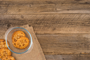 Peanut cookies in a glass bowl on old wooden table.