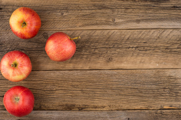Red apples on the old wooden table.
