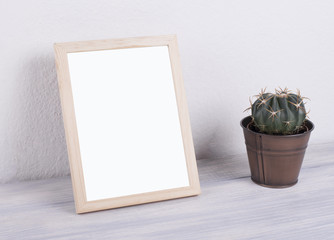 Photo frames next to decorative objects and lavender flower on white and blue wood table. Decor.