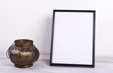 Photo frames next to decorative objects and lavender flower on white and blue wood table. Decor.