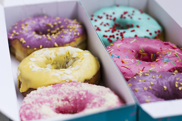 Fresh donuts with colorful glaze in the turquoise box