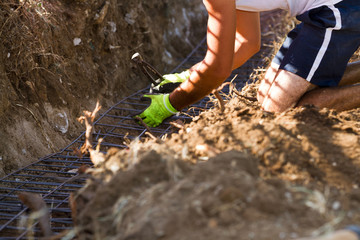 bricklayer making a substructure for a wall