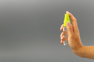 mini bottle sprayer on gray background.