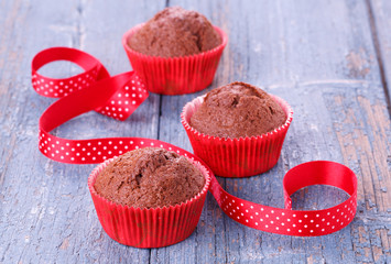 Red muffins on a wooden table