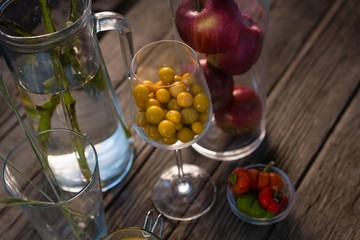 High angle view of winter cherry and apples in container
