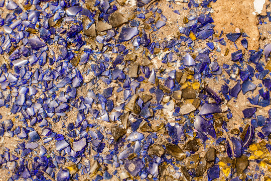 many broken pieces of glass in blue