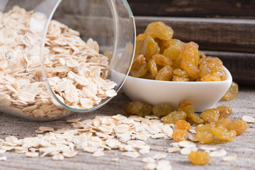 Dry rolled oat flakes oatmeal on old wood table