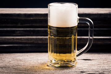 mug of beer on wood background