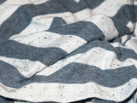 A creased background of striped black and white fabric clothing texture