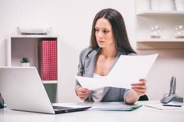 Young businesswoman is working in her office. 