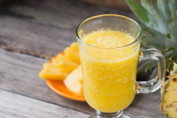 Pineapple smoothie  on wood background