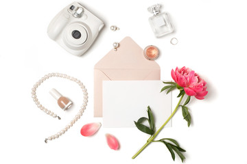 Paper mockup A5 with envelope, cosmetics, instant camera, jewellery and pink peony flower. Blank...