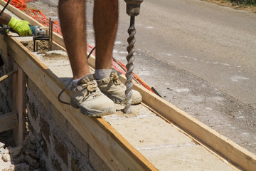 bricklayer building a new wall in a site