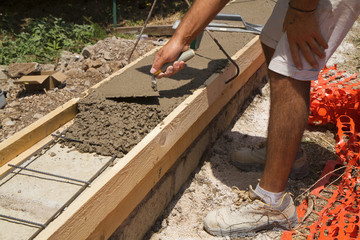 bricklayer building a new wall in a site