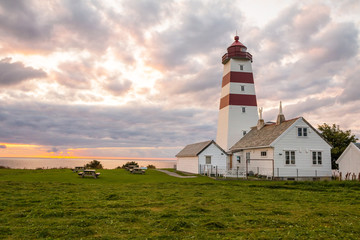 Fototapeta na wymiar Alnes lighthouse at sunset at Godoy island near Alesund, Norway