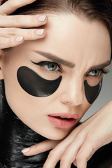 Fototapeta na wymiar Fashion And Beauty. Female Face With Mask And Patches Under Eyes