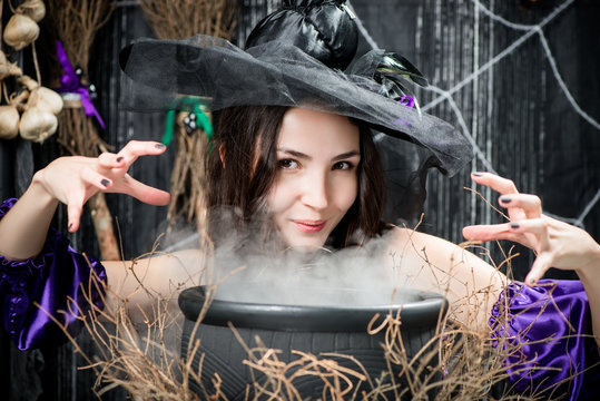 A brunette with brown eyes in the image of a witch above a cauldron