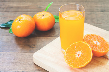 Orange juice with fresh oranges on wood table, Autumn and fall season