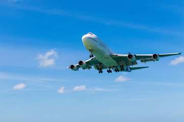 Airplane landing above beautiful beach and sea background