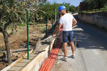 bricklayer building a new wall in a site