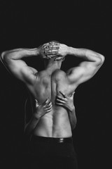 bodybuilder in the women's arms on black background