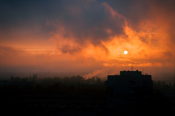 Smoke from plants in the city at sunset