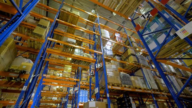 Huge warehouse. Cardboard boxes on shelves inside a storage warehouse. 4K.