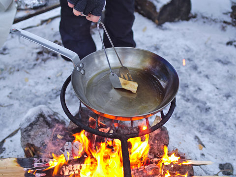 Seasoning Carbon Steel Pan With Lard On Open Camp Fire.