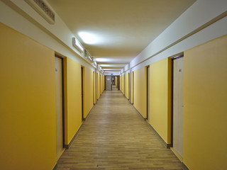 Long empty dormitory corridor with vintage style.