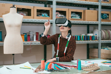 smiling woman worker using virtual reality device - Powered by Adobe