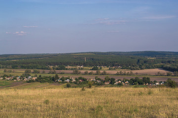 Summer sunny landscape at sunset of the day outside the city.