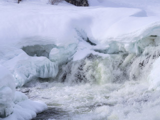 White water in the river Neiden in Norway. Rapids opening in spring. Natural background.