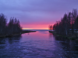 Beautiful red sky at river delta after sunset. Natural background.