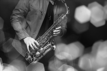 Jazz saxophone player in performance on the stage. color filter and hexagon bokeh added.