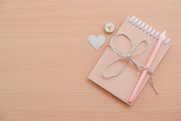  Notepad with pencil on wood board background.using wallpaper for education, business photo.Take note of the product for book with paper and concept or copy space and advertising.