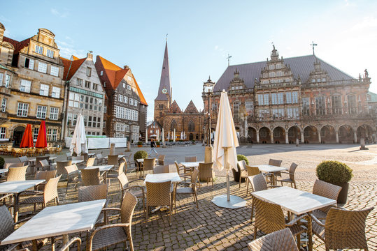 View on the Market square with cafe terrace, city hall and Our Lady church during the morning light in Bremen city, Germany