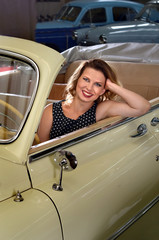 fashionable woman sitting in retro car