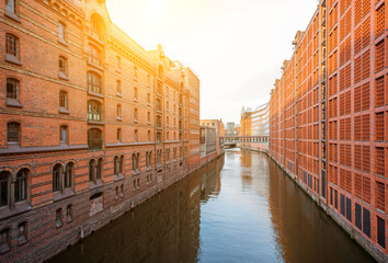 Naklejka premium Beautiful view on the water channel with old red warehouses in Hafen district of Hamburg city, Germany