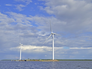 Wind turbines by the sea producing clean energy.
