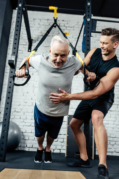 senior sportsman training with trx
