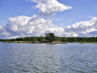 Beautiful scene at the sea with blue sky and cumulus clouds.
