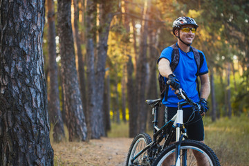 Fototapeta na wymiar man cyclist rides in the forest on a mountain bike.