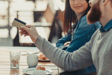 couple paying with credit card in cafe