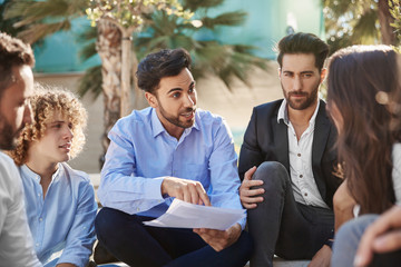 Businessman explaining things to coworkers