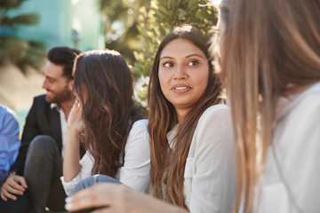 Smiling businesswoman listening intently to coworker