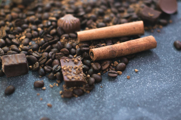 Sweet still life. Coffee beans, chocolate bars and cinnamon sticks.