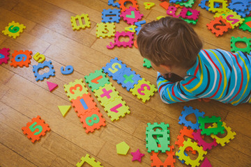 little boy playing with puzzle, education concept