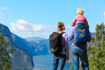 happy young couple with small baby travel in Norway