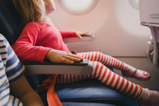 flight safety concept- little girl waiting to take off in plane